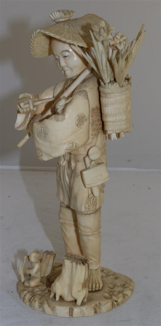 A Japanese sectional ivory figure of a flower seller, early 20th century, 26.5cm A/F